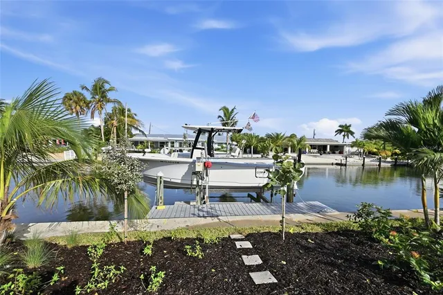 an aerial view of a house with a garden and lake view
