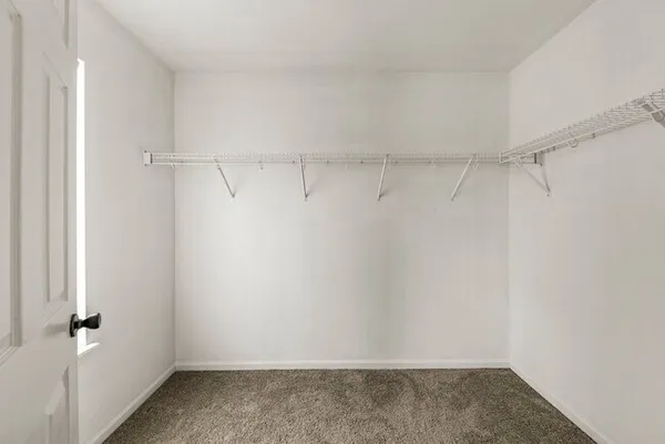 a white bath tub sitting next to a white sink and a shower