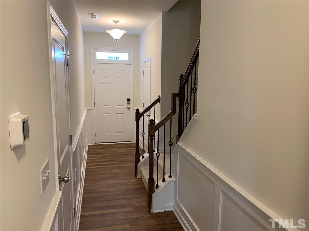 6154 Beale Loop, Unit 91 Raleigh, NC 27616 - Photo 2 of 12 a view of entryway with wooden floor and stairs