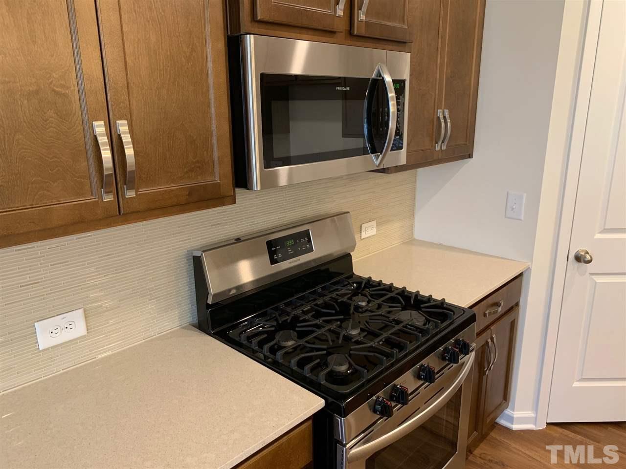 6154 Beale Loop, Unit 91 Raleigh, NC 27616 - Photo 4 of 12 a stove top oven sitting inside of a kitchen