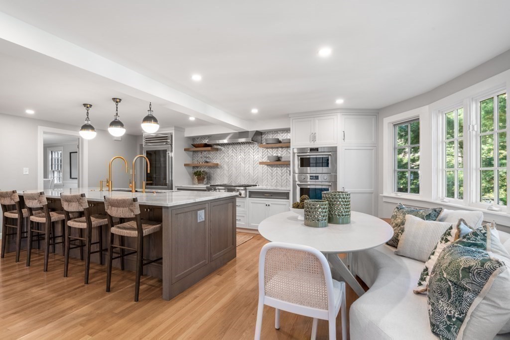 91 Old Colony Road Wellesley, MA 02481 - Photo 17 of 35 a kitchen with microwave a dining table and chairs