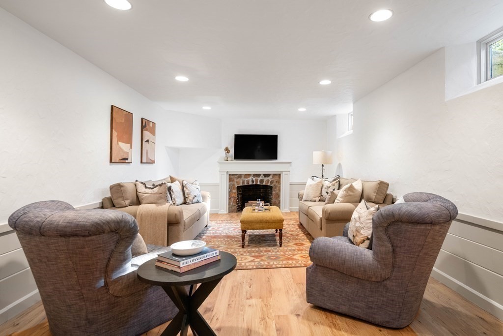 91 Old Colony Road Wellesley, MA 02481 - Photo 28 of 35 a living room with furniture a fireplace and a flat screen tv