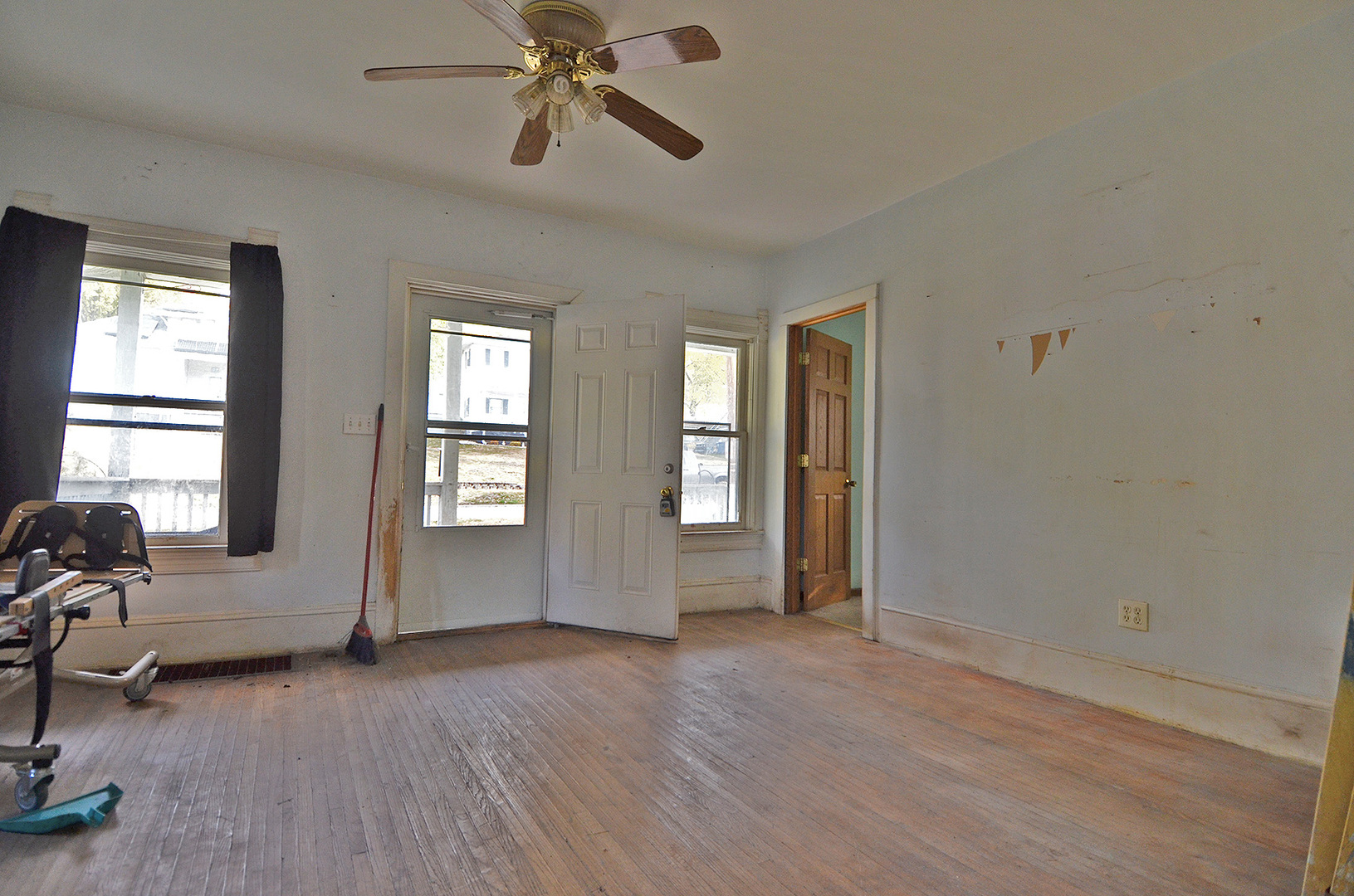266 Clark Street Marseilles, IL 61341 - Photo 3 of 12 a view of empty room with wooden floor and fan