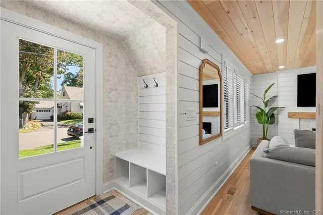 a living room with furniture a flat screen tv and a large window