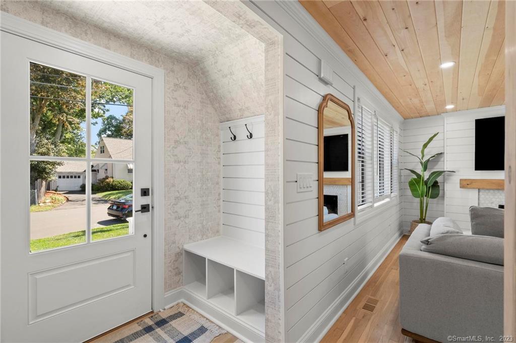 22 Oldfield Drive Fairfield, CT 06824 - Photo 15 of 30 a living room with furniture a flat screen tv and a large window