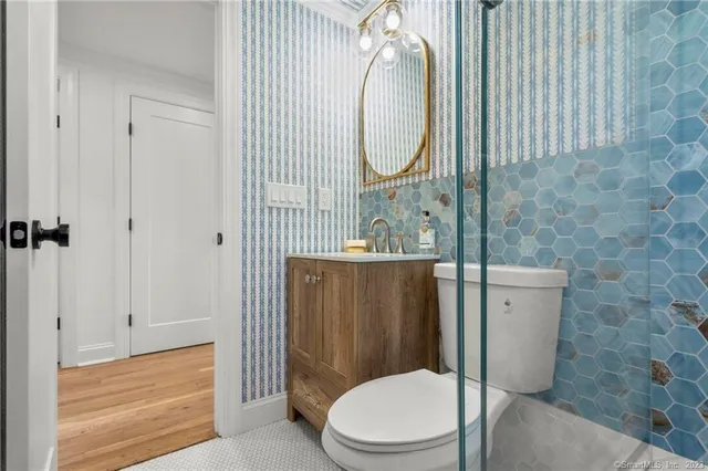 a white toilet sitting next to a bathroom sink