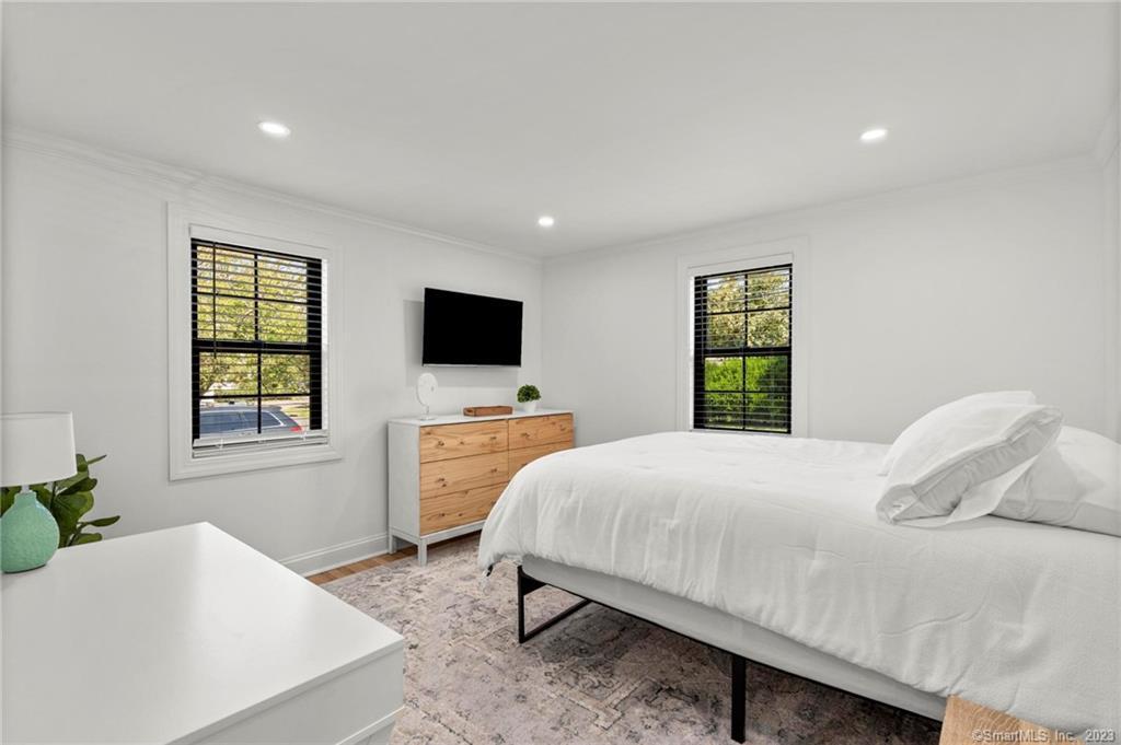 22 Oldfield Drive Fairfield, CT 06824 - Photo 19 of 30 a bedroom with a bed and a flat screen tv