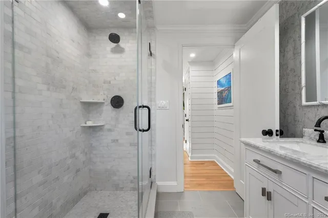 a bathroom with a granite countertop shower and a sink