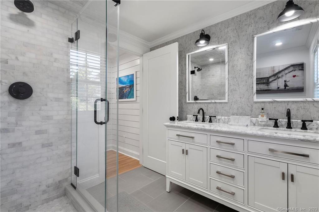 22 Oldfield Drive Fairfield, CT 06824 - Photo 22 of 30 a spacious bathroom with a shower sink and mirror