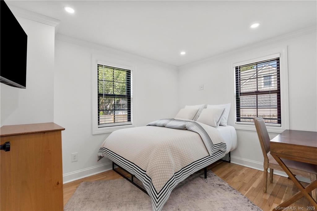22 Oldfield Drive Fairfield, CT 06824 - Photo 23 of 30 a bed room with a bed tv and a window