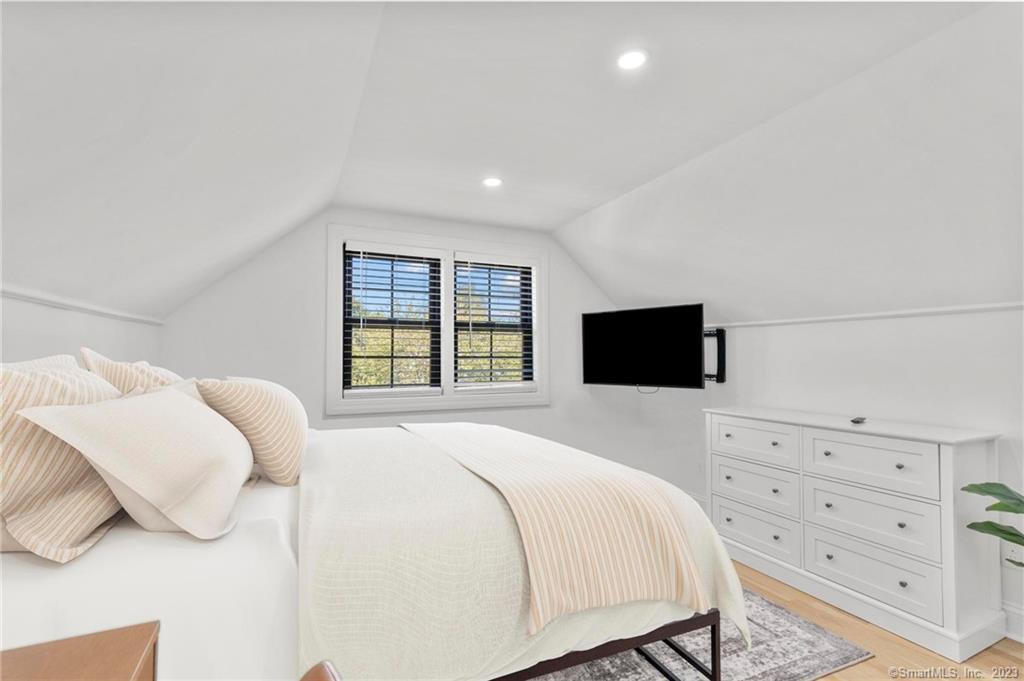 22 Oldfield Drive Fairfield, CT 06824 - Photo 25 of 30 a bedroom with a bed and a flat screen tv