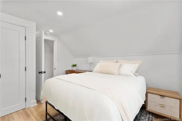 a bedroom with a bed and a night stand