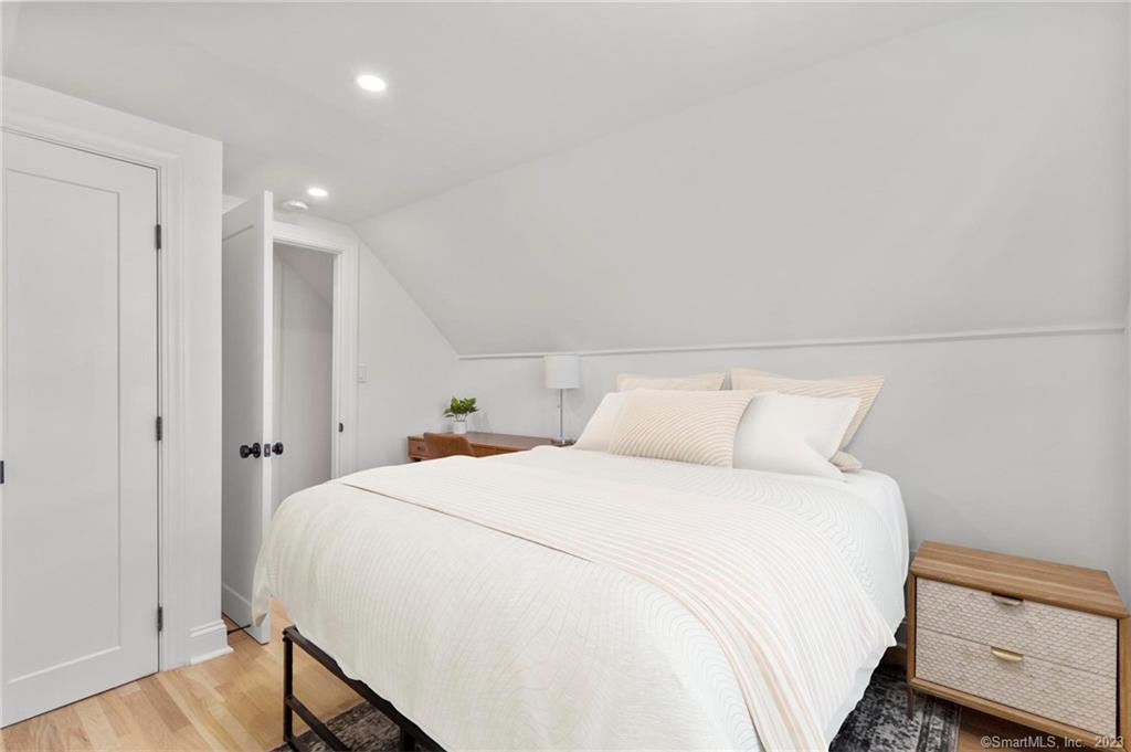 22 Oldfield Drive Fairfield, CT 06824 - Photo 26 of 30 a bedroom with a bed and a night stand