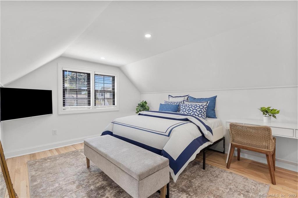 22 Oldfield Drive Fairfield, CT 06824 - Photo 27 of 30 a bedroom with a bed and a flat screen tv