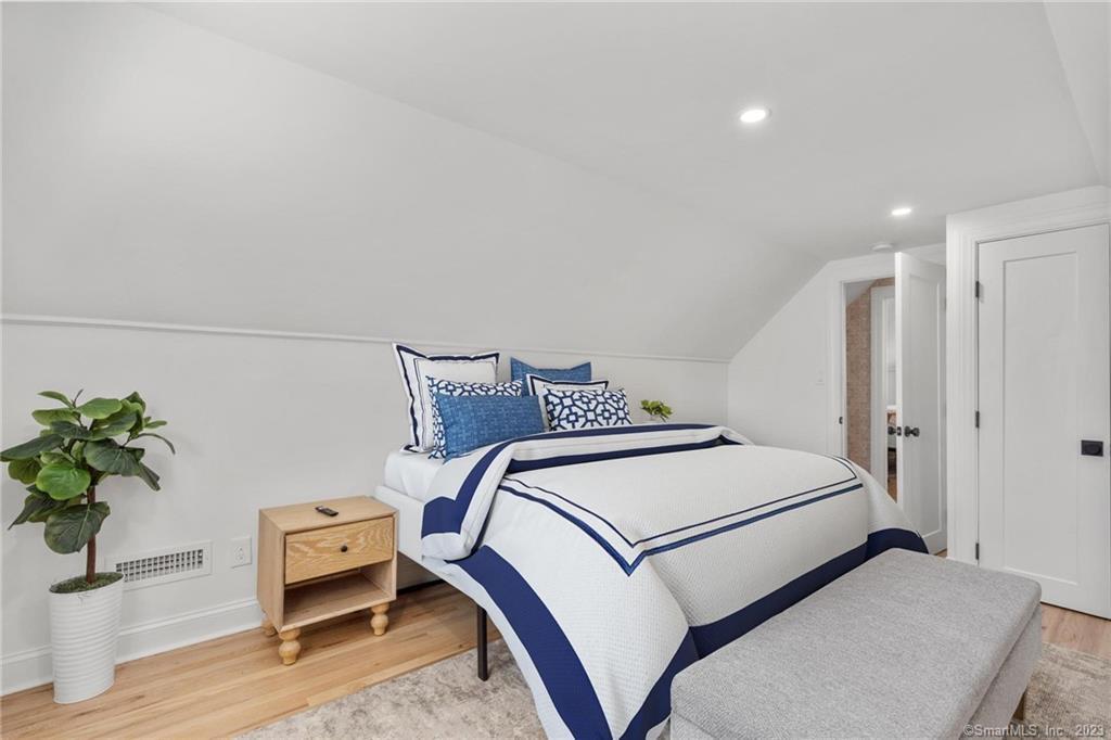 22 Oldfield Drive Fairfield, CT 06824 - Photo 28 of 30 a bedroom with a bed and a potted plant