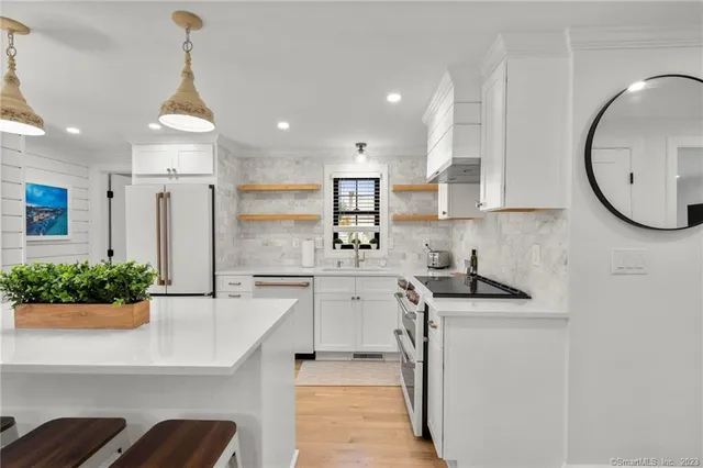 a kitchen with stainless steel appliances granite countertop a sink and cabinets