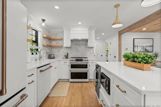 a kitchen with stainless steel appliances granite countertop a sink and stove top oven