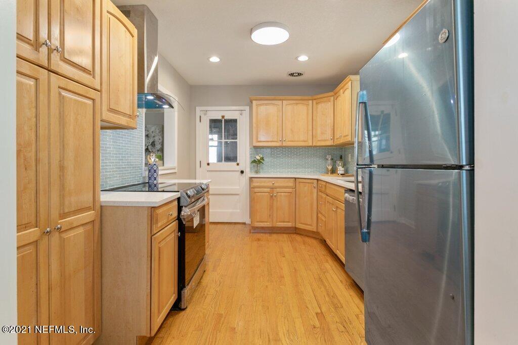 1642 Clemson Road Jacksonville, FL 32217 - Photo 10 of 35 a kitchen with a refrigerator sink and cabinets