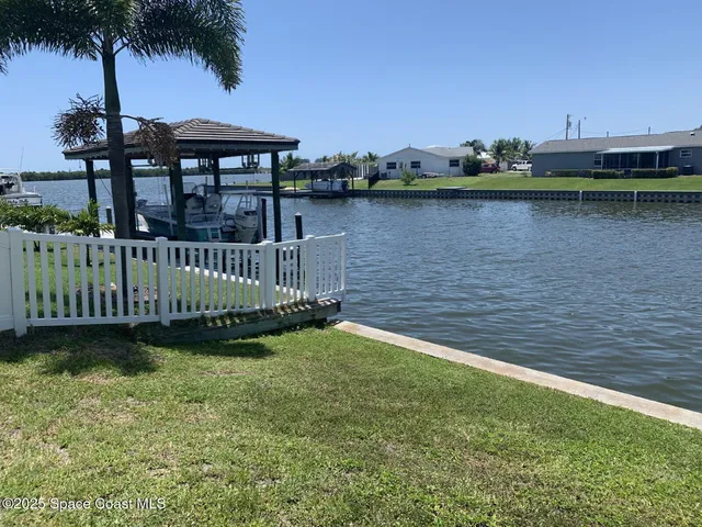 a view of a garden with sitting area and lake view