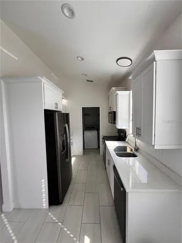 a kitchen with stainless steel appliances granite countertop a refrigerator and a stove