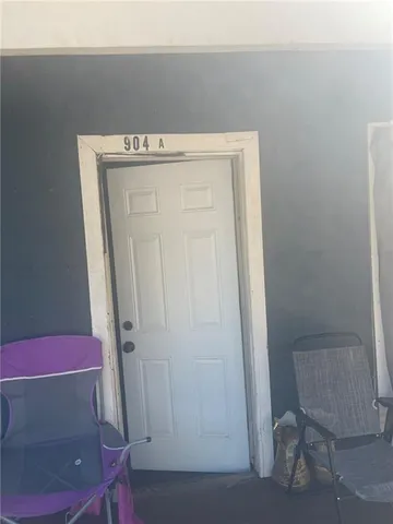 a living room with furniture a flat screen tv and a clock