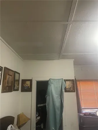 a bed sitting in a room next to a lamp
