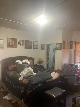 a bedroom with a bed and dresser with mirror