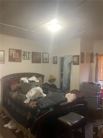 a bedroom with a bed and dresser with mirror