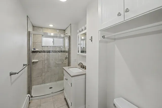a bathroom with a shower and mirror