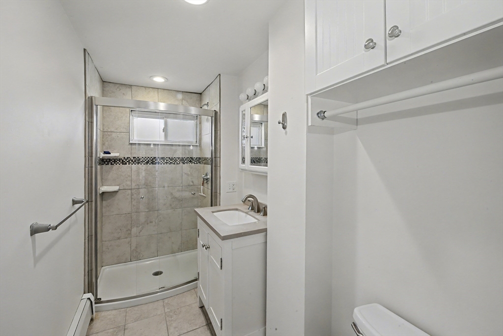 46 Waverly Street, Unit 2 Boston, MA 02135 - Photo 11 of 18 a bathroom with a shower and mirror