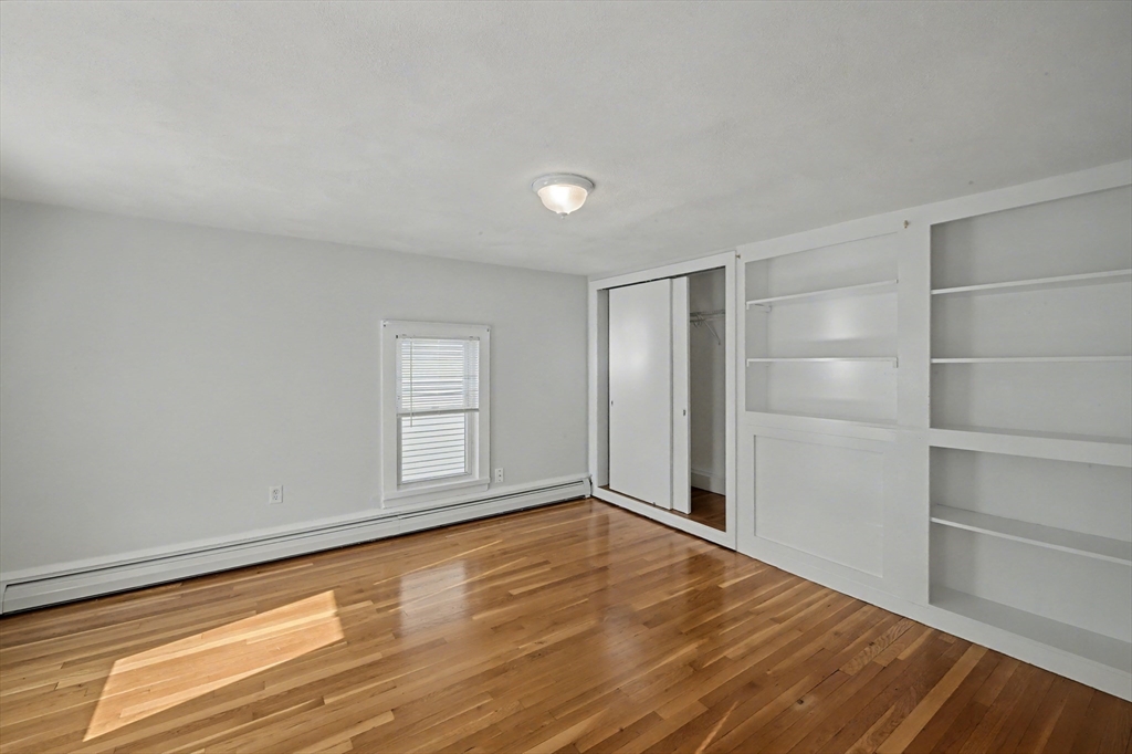 46 Waverly Street, Unit 2 Boston, MA 02135 - Photo 5 of 18 a view of empty room with wooden floor and fan