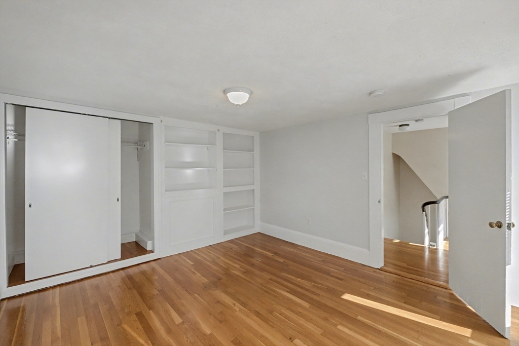46 Waverly Street, Unit 2 Boston, MA 02135 - Photo 6 of 18 a view of empty room with wooden floor