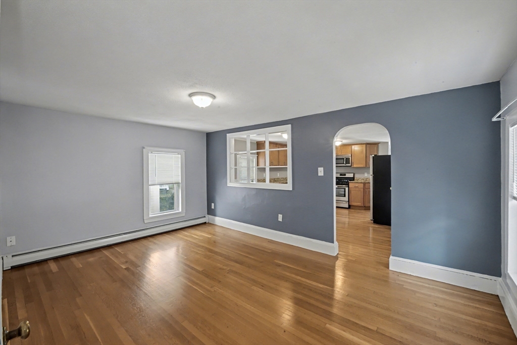 46 Waverly Street, Unit 2 Boston, MA 02135 - Photo 9 of 18 wooden floor in an empty room with a window