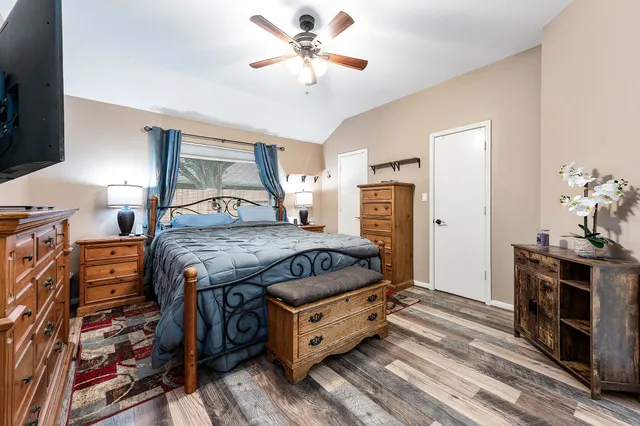 a spacious bedroom with a bed and a chandelier