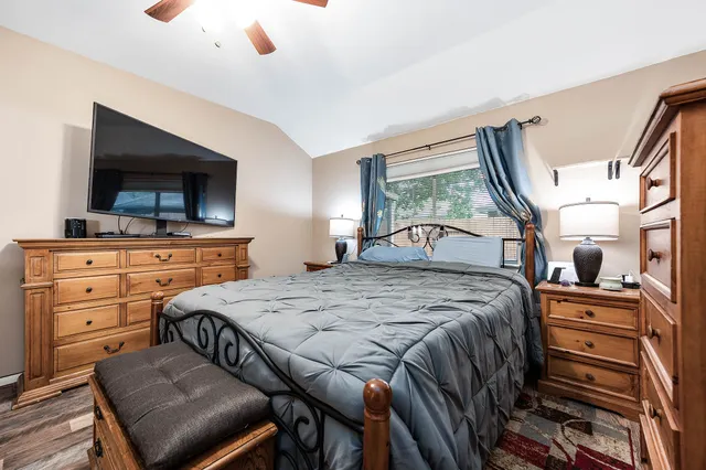 a bedroom with a bed and a flat screen tv