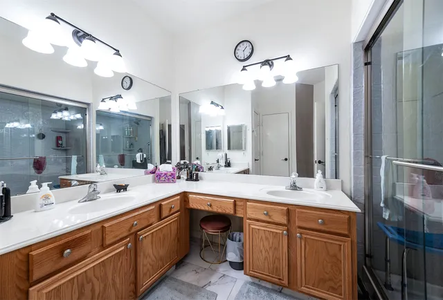a bathroom with a double vanity sink and a mirror