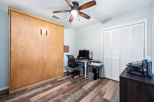 a view of a workspace with furniture and a window