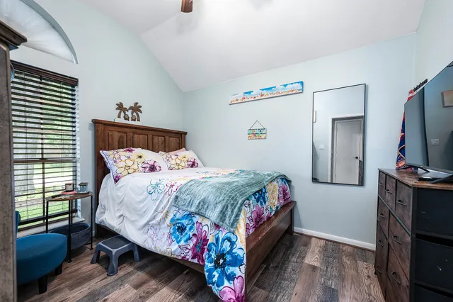 a bedroom with a bed and a flat screen tv