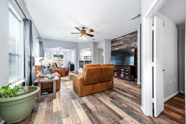 a living room with furniture and a potted plant