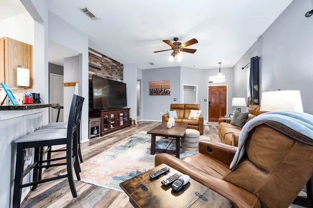 a living room with furniture and a flat screen tv