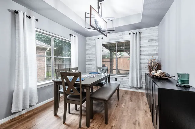 a view of a dining room with furniture window and wooden floor