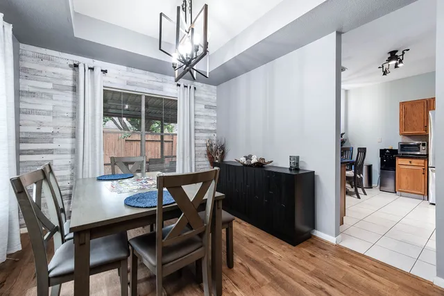 a view of a dining room with furniture and chandelier