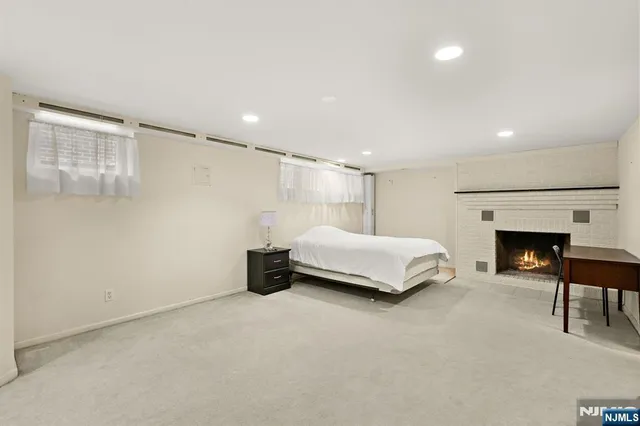 a bedroom with a bed and a fireplace