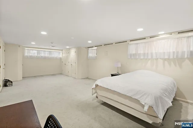 a large bed sitting in a room next to a window