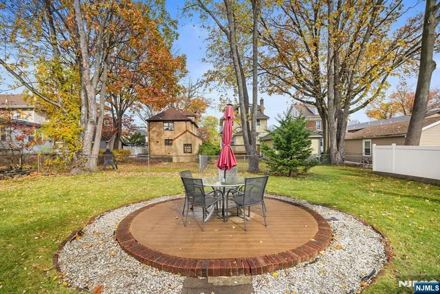 a view of a house with backyard sitting area and garden