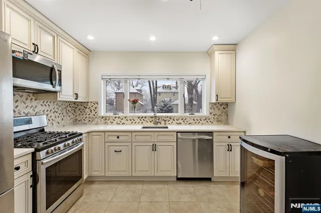 a kitchen with stainless steel appliances granite countertop a stove and a sink