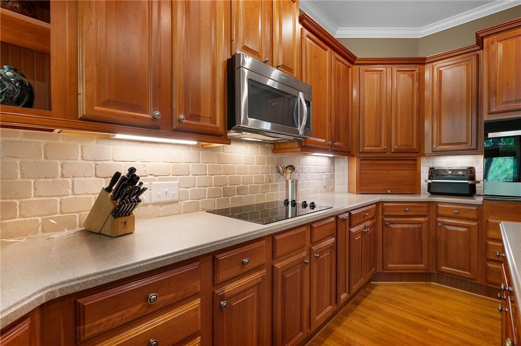 208 Muirfield Way Jasper, GA 30143 - Photo 18 of 59 a kitchen with stainless steel appliances granite countertop wooden cabinets a sink and dishwasher