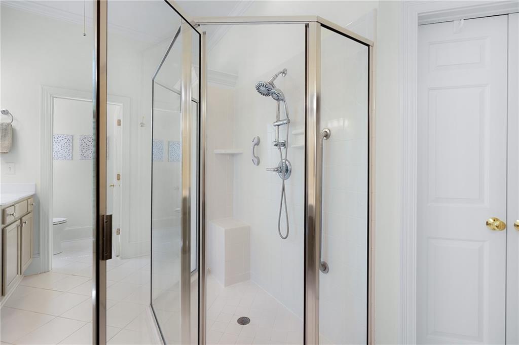 208 Muirfield Way Jasper, GA 30143 - Photo 29 of 59 a bathroom with a glass shower door and a glass door