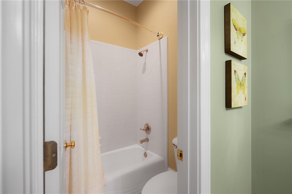 208 Muirfield Way Jasper, GA 30143 - Photo 35 of 59 a bathroom with a bathtub and a shower