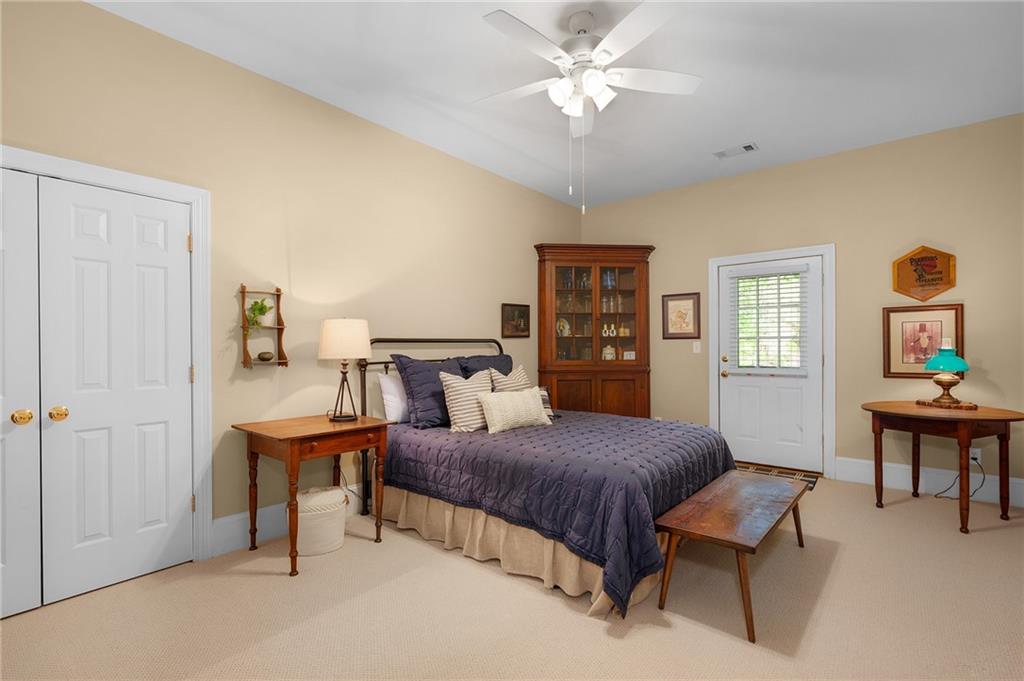208 Muirfield Way Jasper, GA 30143 - Photo 42 of 59 a bedroom with a bed and a table in it
